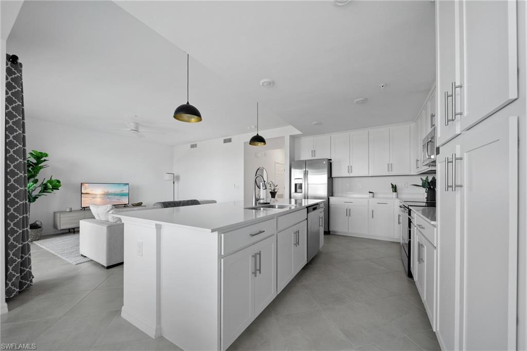 43997 Boardwalk Loop, Unit 1837 Babcock Ranch, FL 33982 - Photo 6 of 26 a kitchen with refrigerator and cabinets