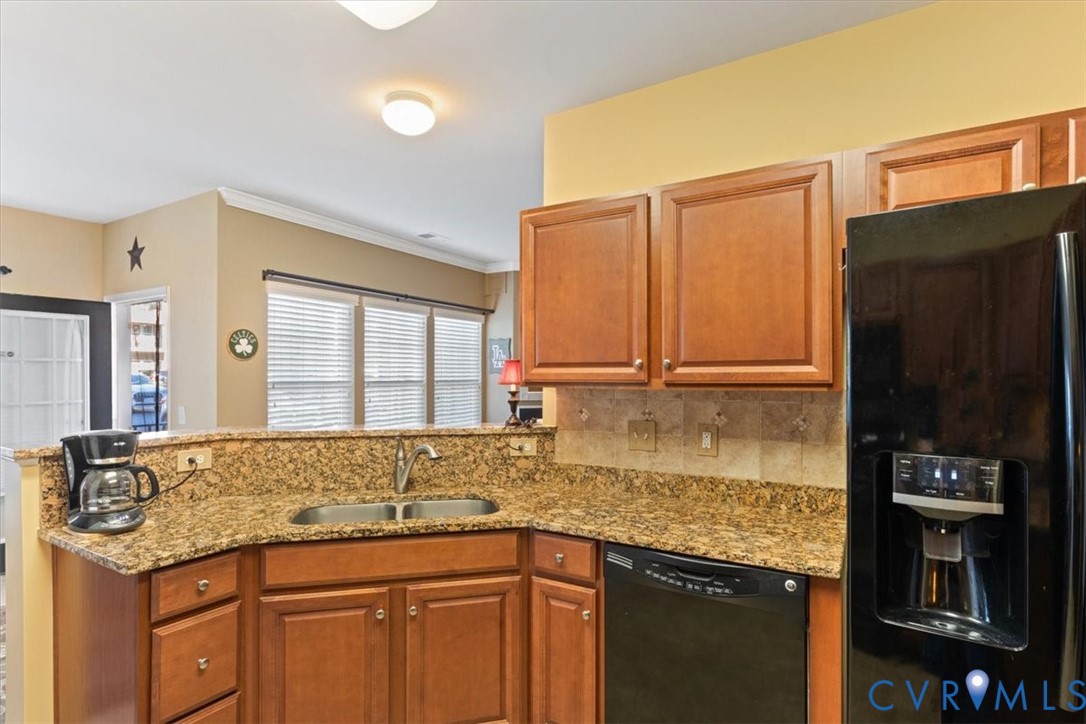 14011 Briars Circle, Unit 104 Midlothian, VA 23114 - Photo 13 of 22 a kitchen with granite countertop a sink and a refrigerator