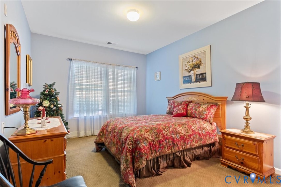 14011 Briars Circle, Unit 104 Midlothian, VA 23114 - Photo 18 of 22 a bedroom with a bed and wooden floor