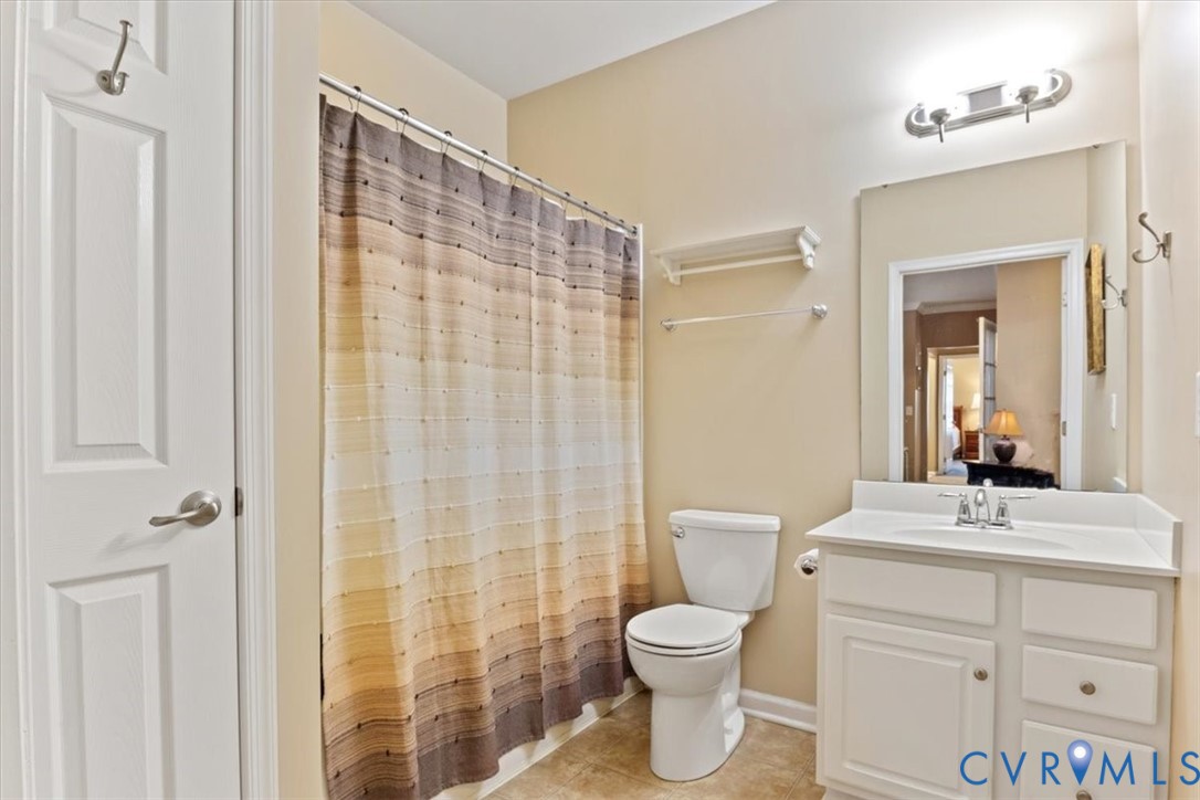 14011 Briars Circle, Unit 104 Midlothian, VA 23114 - Photo 19 of 22 a bathroom with a toilet a sink and a mirror