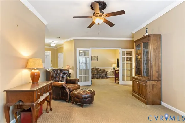 a view of a livingroom with furniture and a ceiling fan