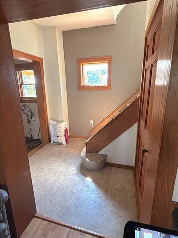 a view of a livingroom with wooden floor and stairs