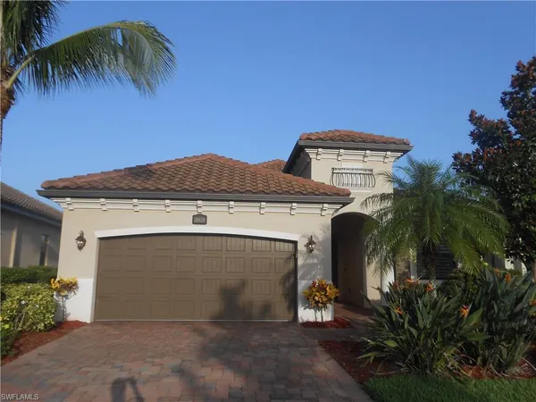a front view of a house with yard and garage
