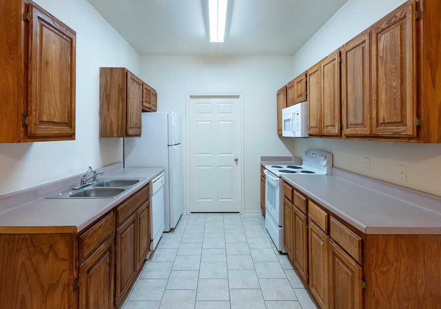 2201 Sycamore School Road Fort Worth, TX 76134 - Photo 8 of 12 a kitchen with stainless steel appliances granite countertop a sink stove and cabinets