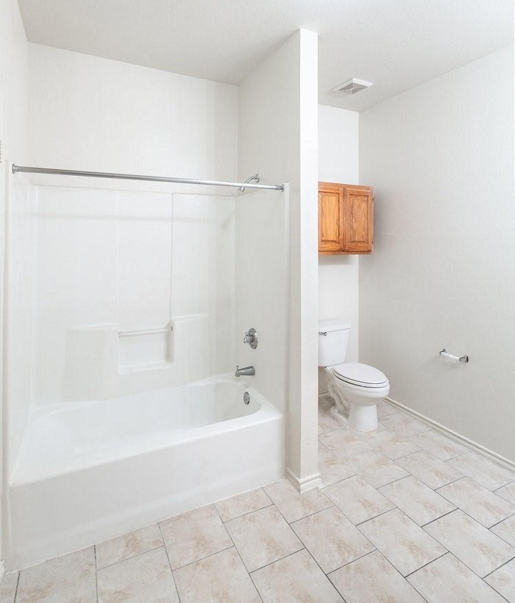 2201 Sycamore School Road Fort Worth, TX 76134 - Photo 10 of 12 a bathroom with a toilet and a bathtub