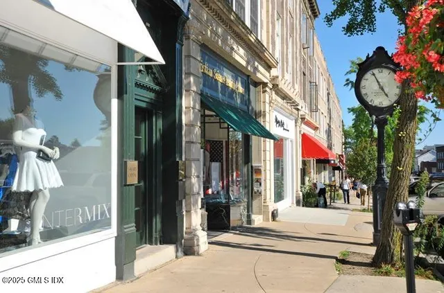 a view of a street with stores