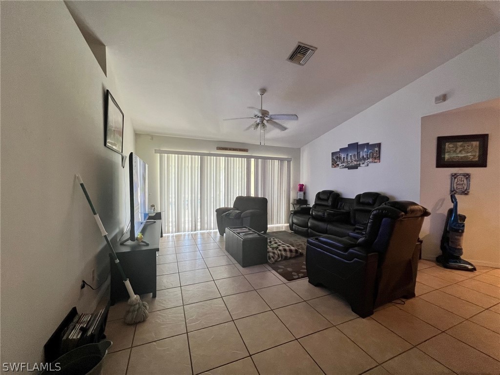 351 Ranch Avenue Lehigh Acres, FL 33974 - Photo 4 of 13 a living room with furniture and a flat screen tv