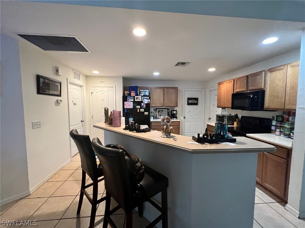 351 Ranch Avenue Lehigh Acres, FL 33974 - Photo 6 of 13 a kitchen with a sink a counter space appliances and cabinets