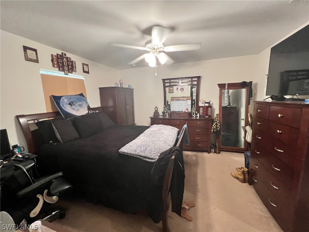 351 Ranch Avenue Lehigh Acres, FL 33974 - Photo 8 of 13 a living room with furniture and a flat screen tv