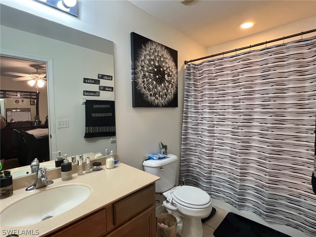 351 Ranch Avenue Lehigh Acres, FL 33974 - Photo 9 of 13 a bathroom with a toilet sink vanity and mirror