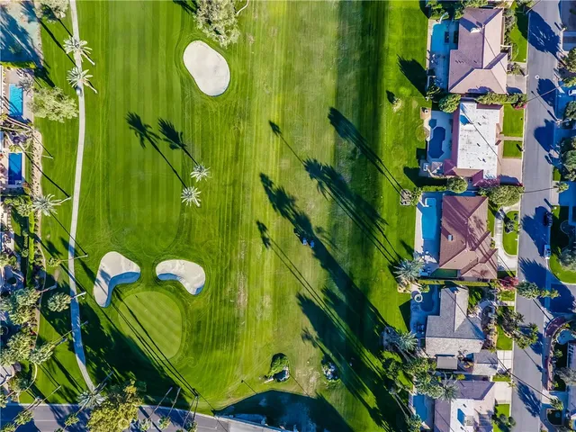 a view of a patio with table and chairs plants and large trees