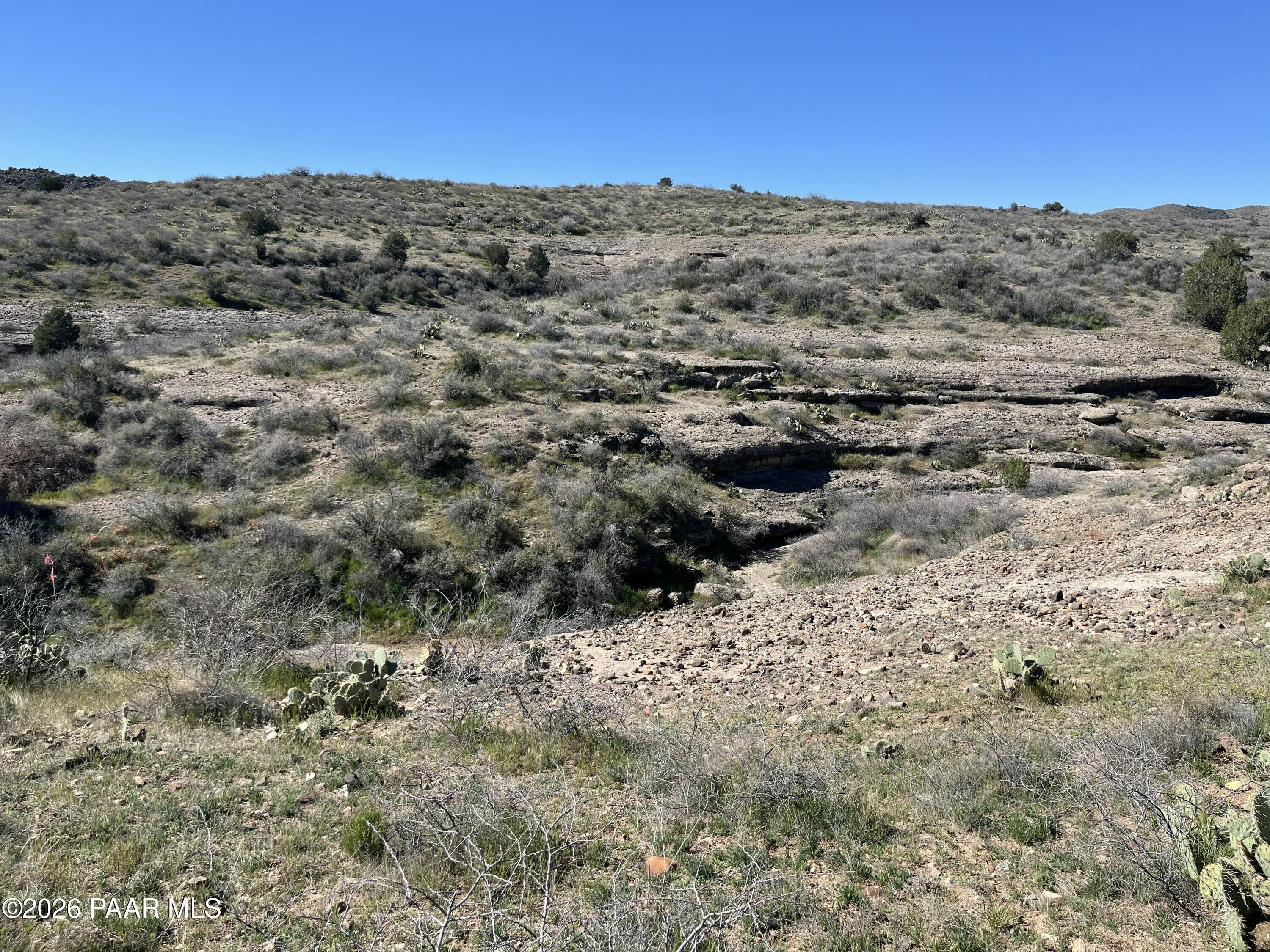 0 South Walnut Grove Road Kirkland, AZ 86332 - Photo 10 of 15 a view of a dry yard with mountains in the background