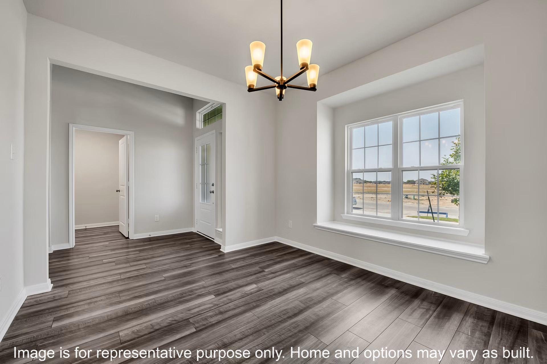 237 Lazy Lizzy Road Jarrell, TX 76537 - Photo 11 of 18 Rich wood-look flooring and a deep bay window ledge define this versatile space.