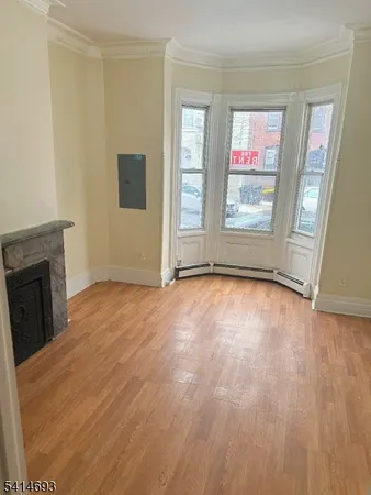 a view of empty room with window and fireplace