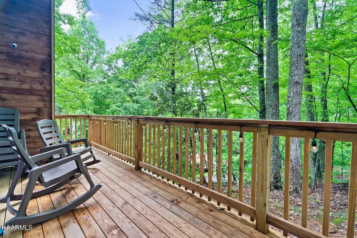 1424 Zurich Road Gatlinburg, TN 37738 - Photo 11 of 27 a view of a balcony with wooden floor and outdoor seating