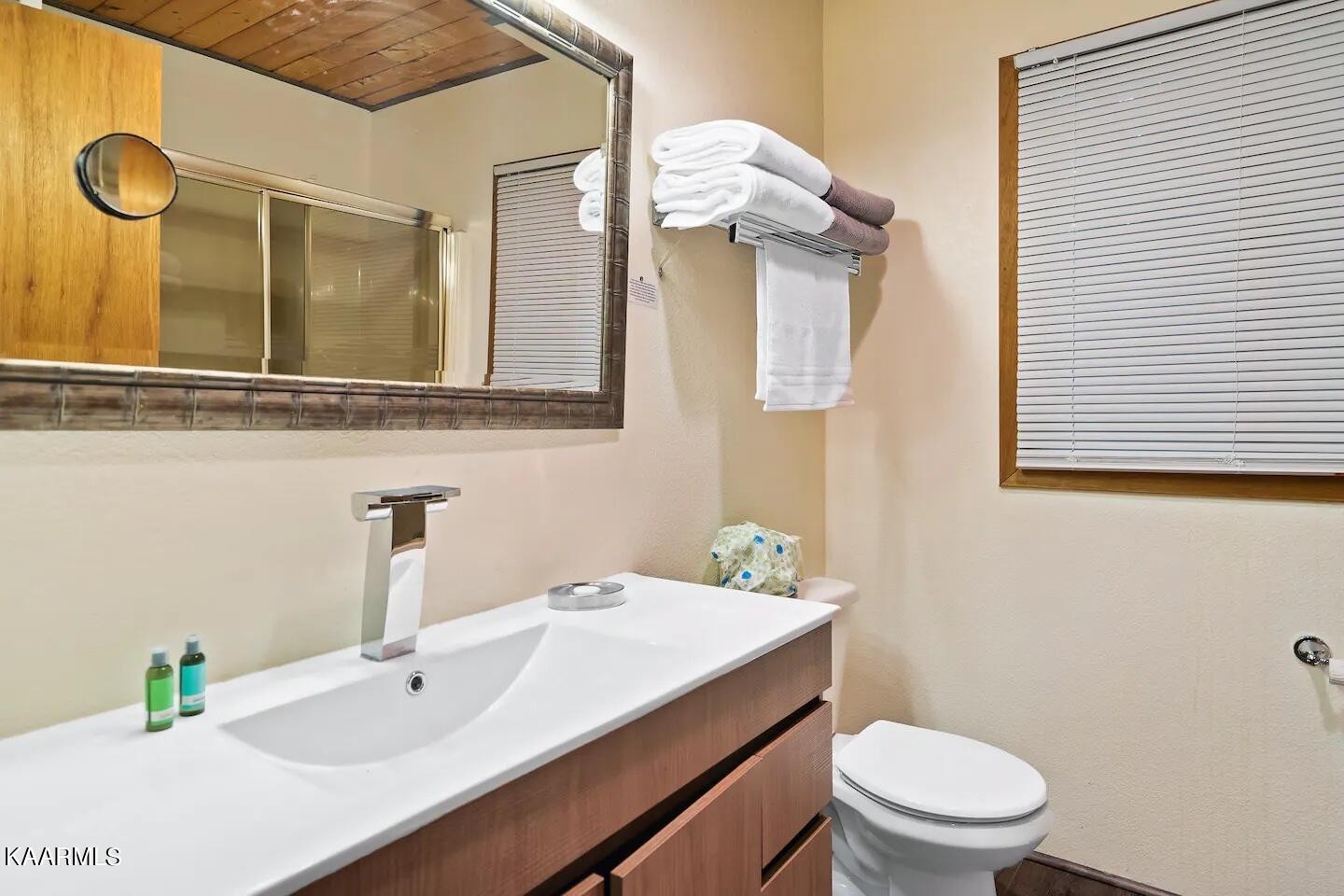 1424 Zurich Road Gatlinburg, TN 37738 - Photo 16 of 27 a bathroom with a sink a toilet and mirror