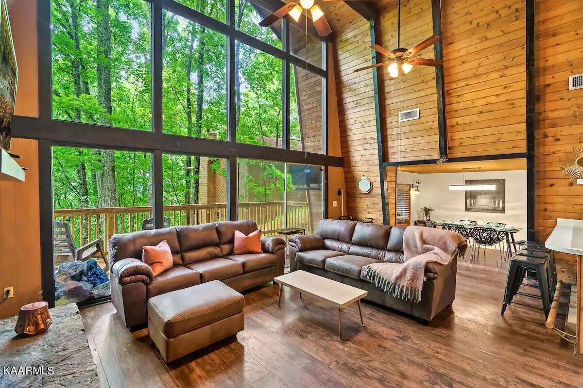 1424 Zurich Road Gatlinburg, TN 37738 - Photo 6 of 27 a living room with furniture and floor to ceiling windows