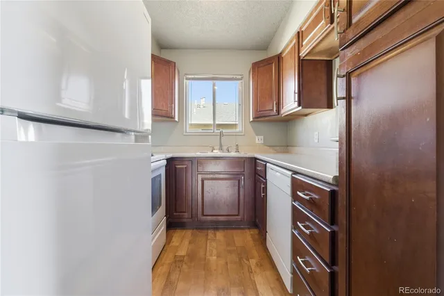 a kitchen with a sink a stove and cabinets