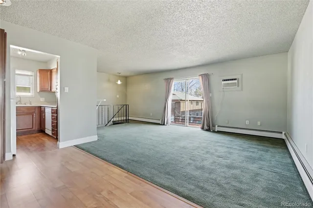 an empty room with windows and cabinet