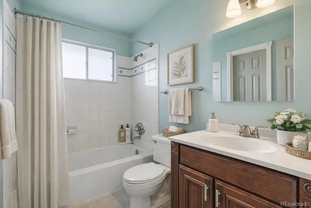 a bathroom with a sink toilet tub and shower