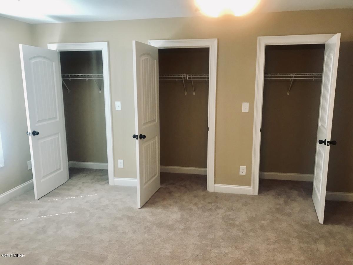 5890 Forsyth Road Macon, GA 31210 - Photo 3 of 11 an empty room with closet and wooden door