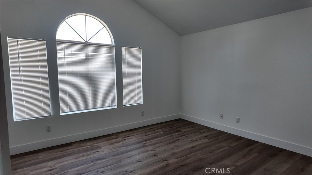 21484 Dickinson Road Moreno Valley, CA 92557 - Photo 10 of 10 an empty room with wooden floor and windows