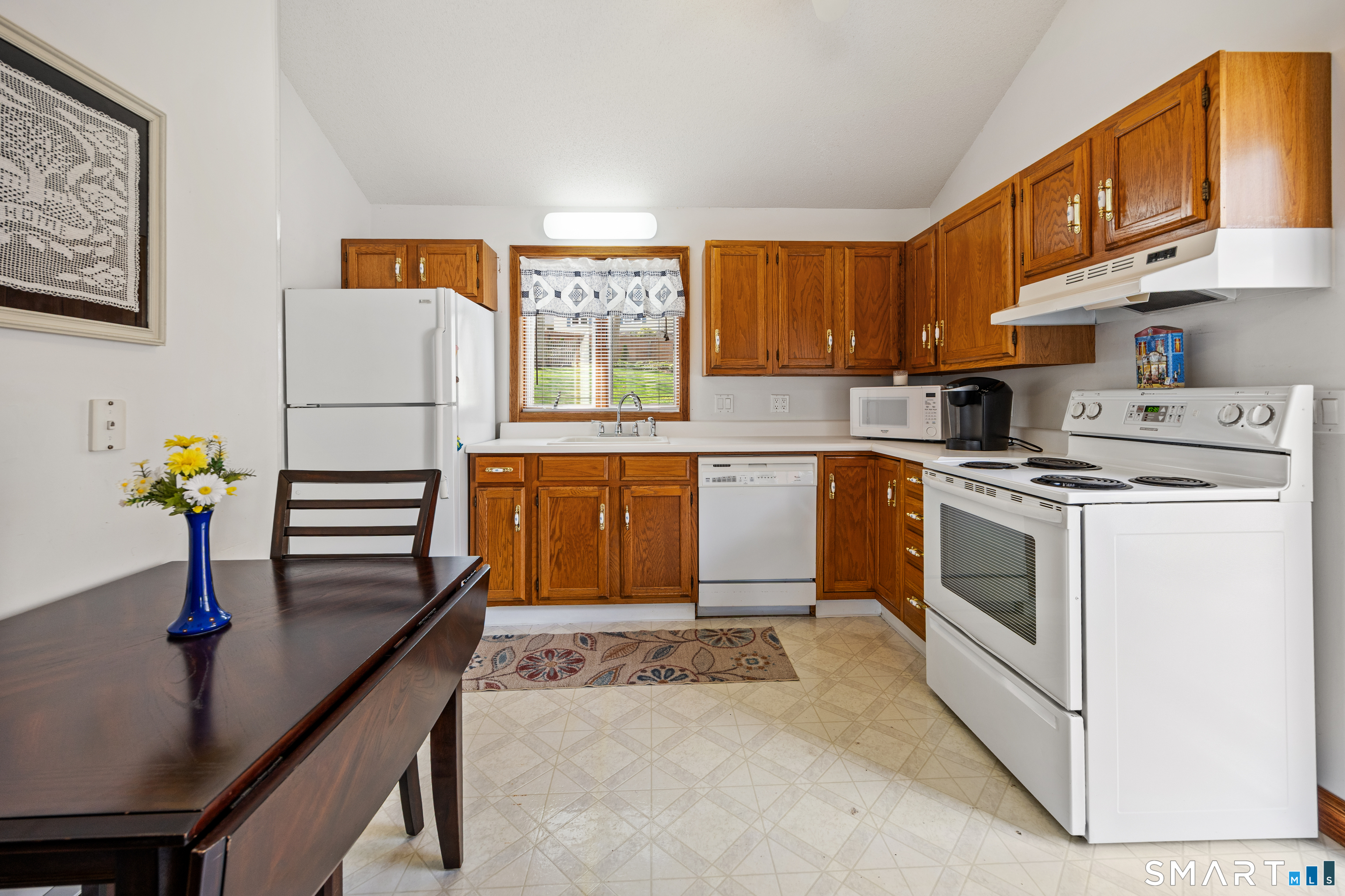 42 Chimney Sweep Road Wallingford, CT 06492 - Photo 29 of 40 a kitchen with stainless steel appliances a stove a sink and a refrigerator