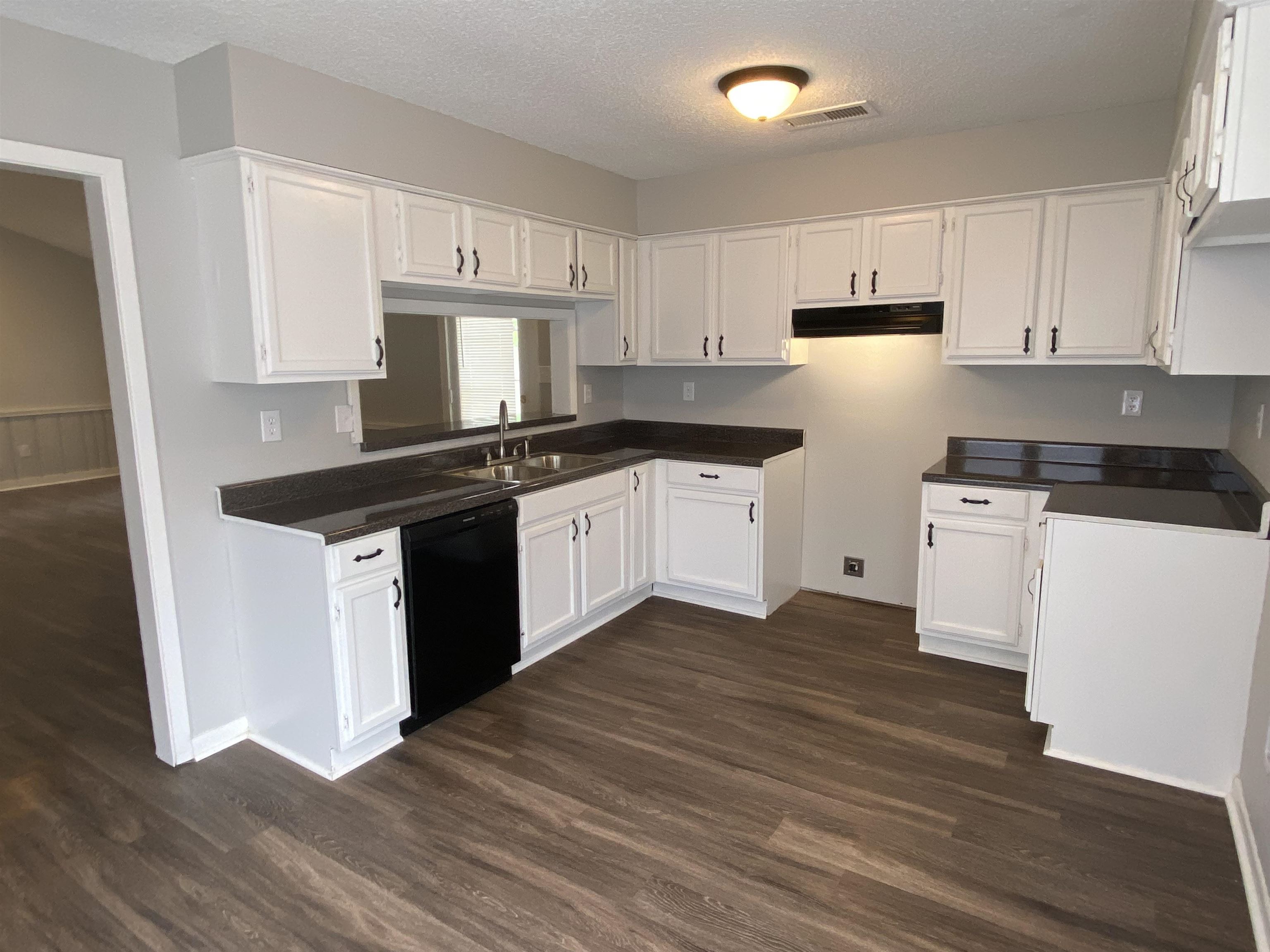 3891 Ross Road Memphis, TN 38115 - Photo 8 of 18 a kitchen with a sink cabinets and wooden floor