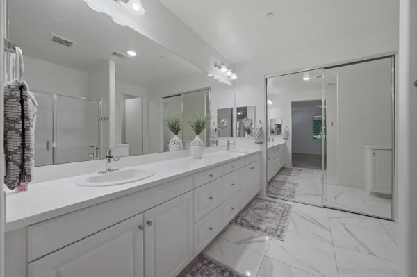 a bathroom with a double vanity sink and a mirror