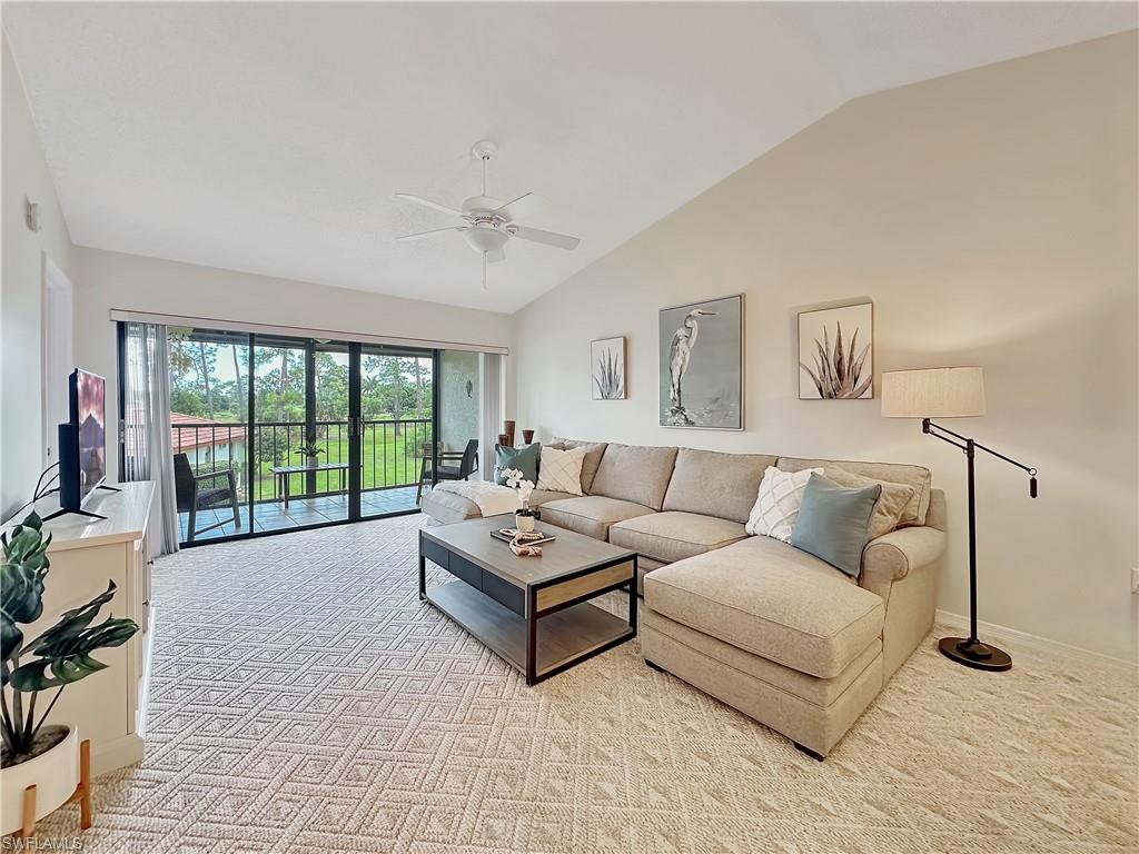905 Augusta Boulevard, Unit 9056 Naples, FL 34113 - Photo 12 of 28 Living room with ceiling fan, light carpet, and vaulted ceiling