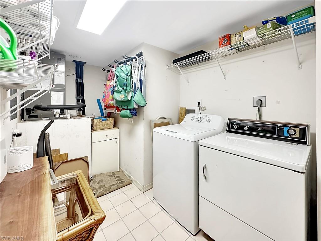 905 Augusta Boulevard, Unit 9056 Naples, FL 34113 - Photo 25 of 28 Washroom with light tile patterned floors and independent washer and dryer