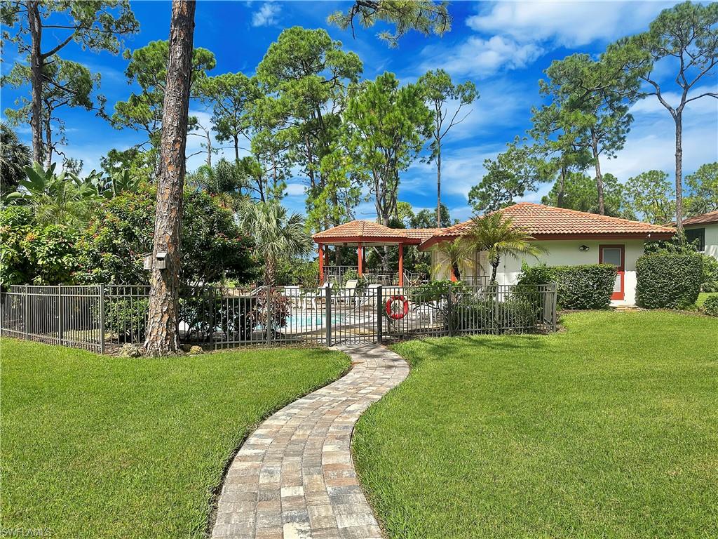 905 Augusta Boulevard, Unit 9056 Naples, FL 34113 - Photo 26 of 28 View of front of house with a front lawn, a patio, a fenced in pool, and a gazebo