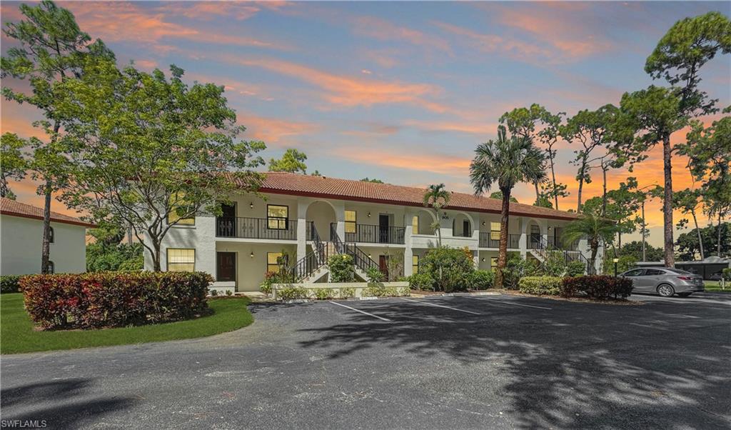 905 Augusta Boulevard, Unit 9056 Naples, FL 34113 - Photo 28 of 28 View of outdoor building at dusk