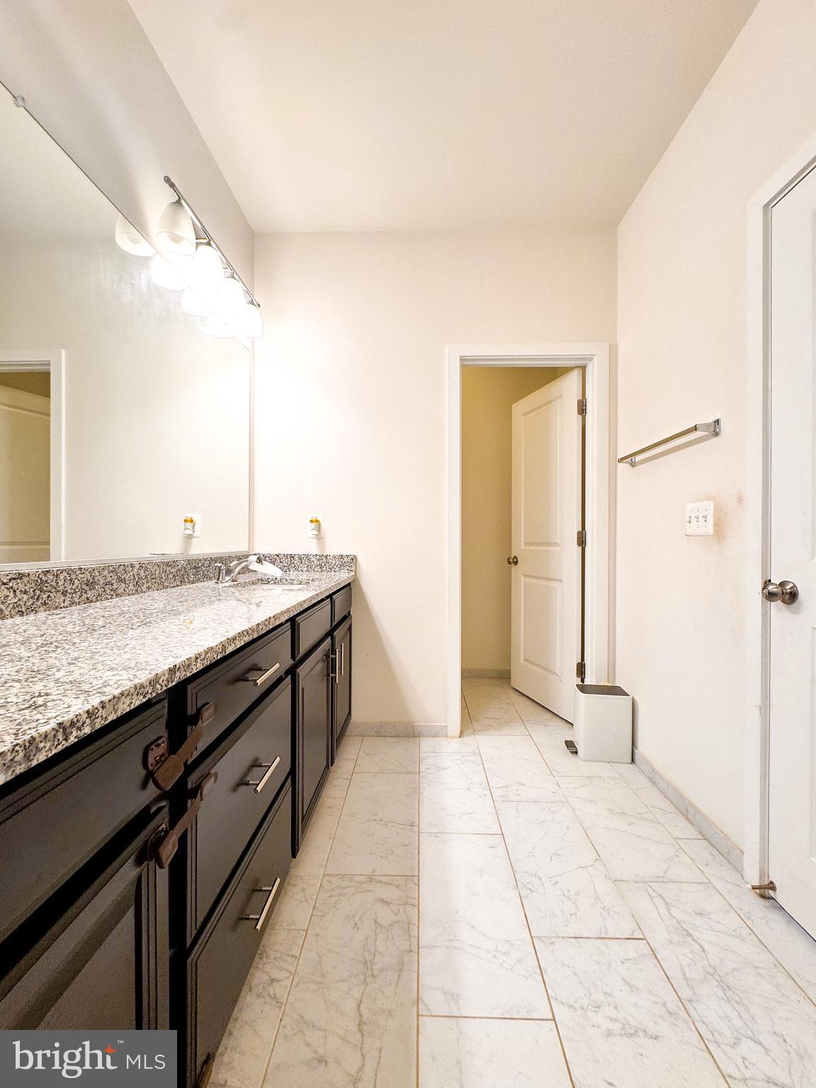 25419 Reed Orchard Terrace Chantilly, VA 20152 - Photo 32 of 47 a spacious bathroom with a granite countertop sink and a mirror
