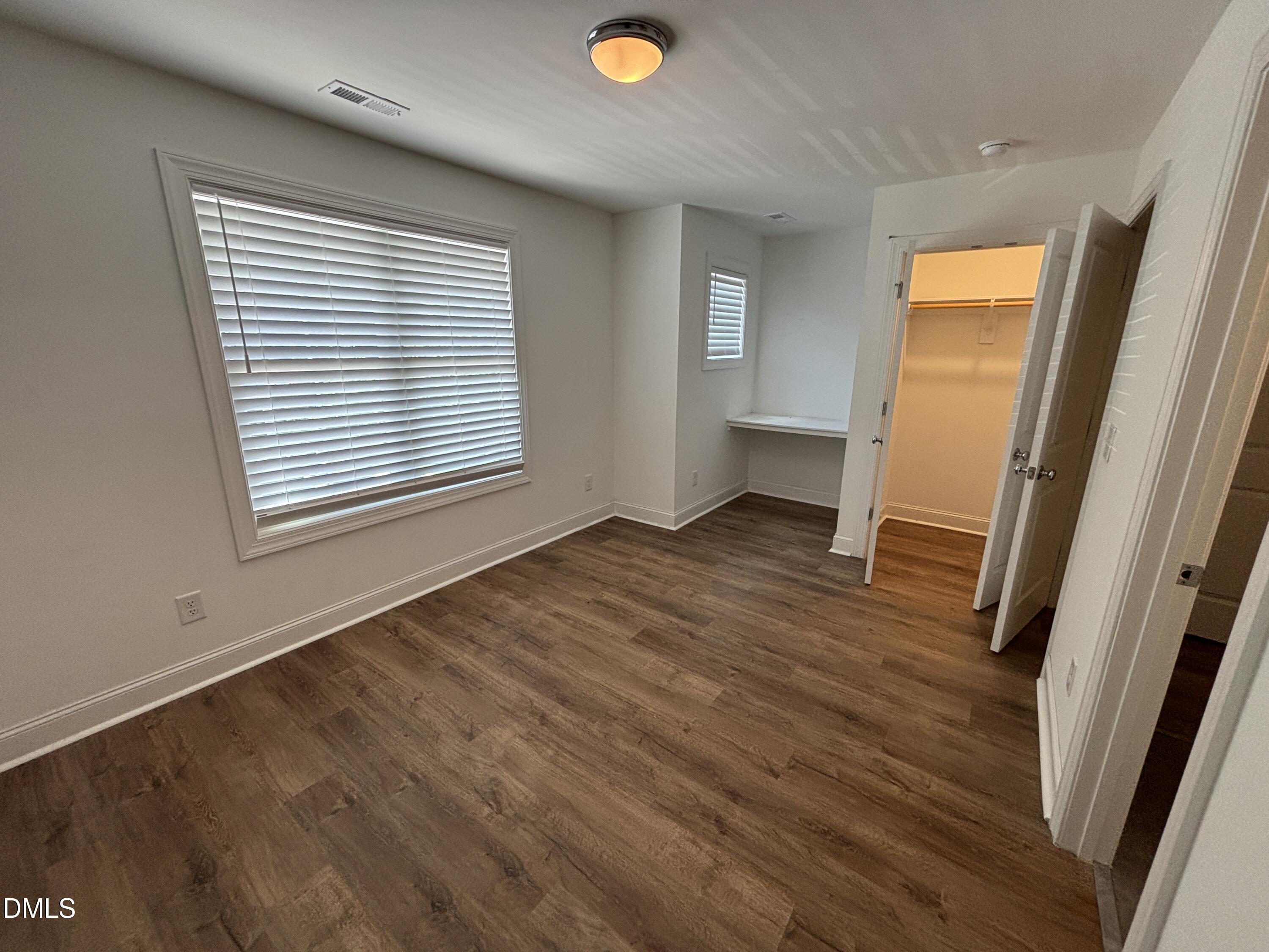 5710 Parker Pnes Court Raleigh, NC 27609 - Photo 65 of 78 a view of an empty room with wooden floor and a window