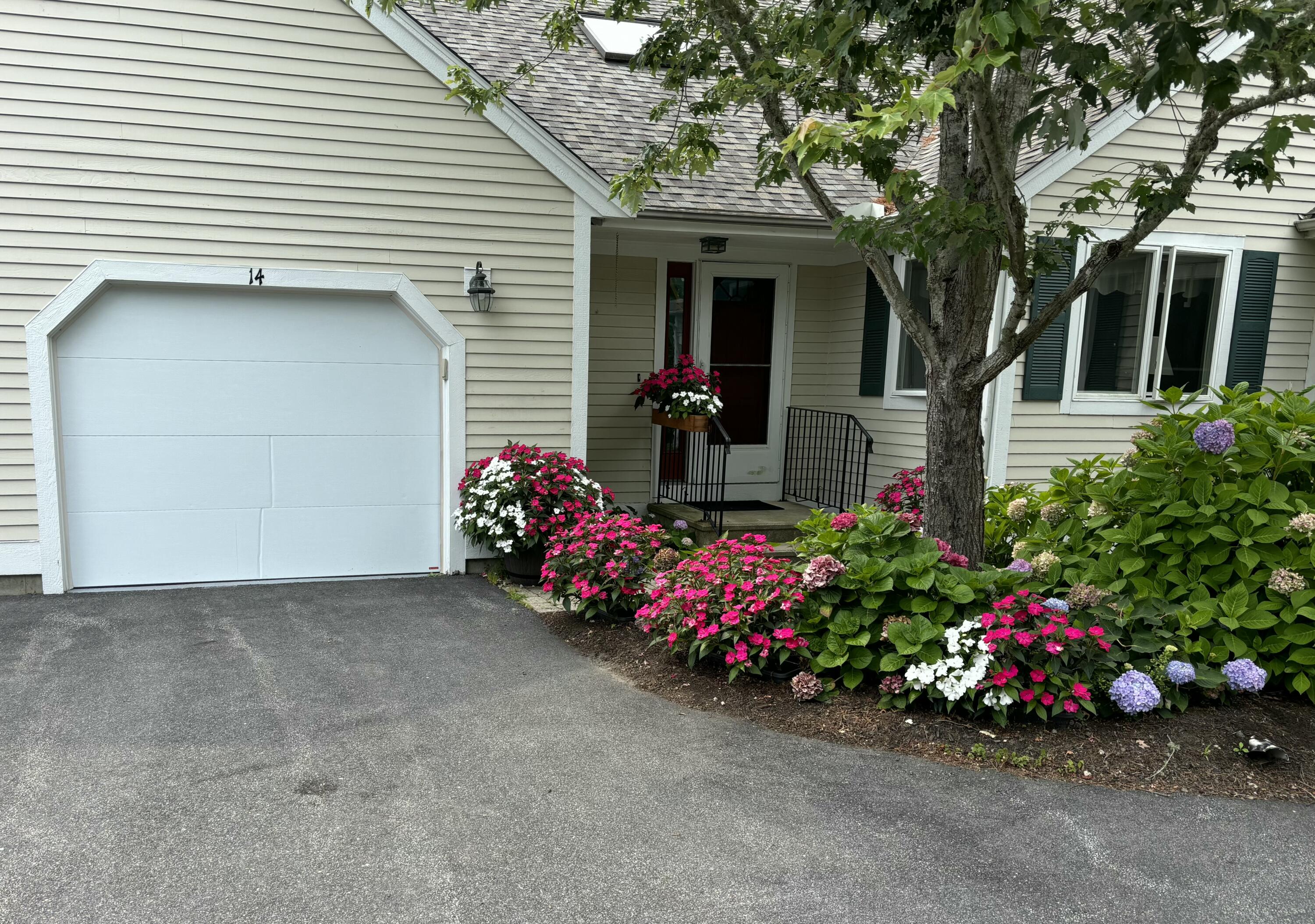 14 Pga Lane Mashpee, MA 02649 - Photo 1 of 14 a view of a house with a flower garden