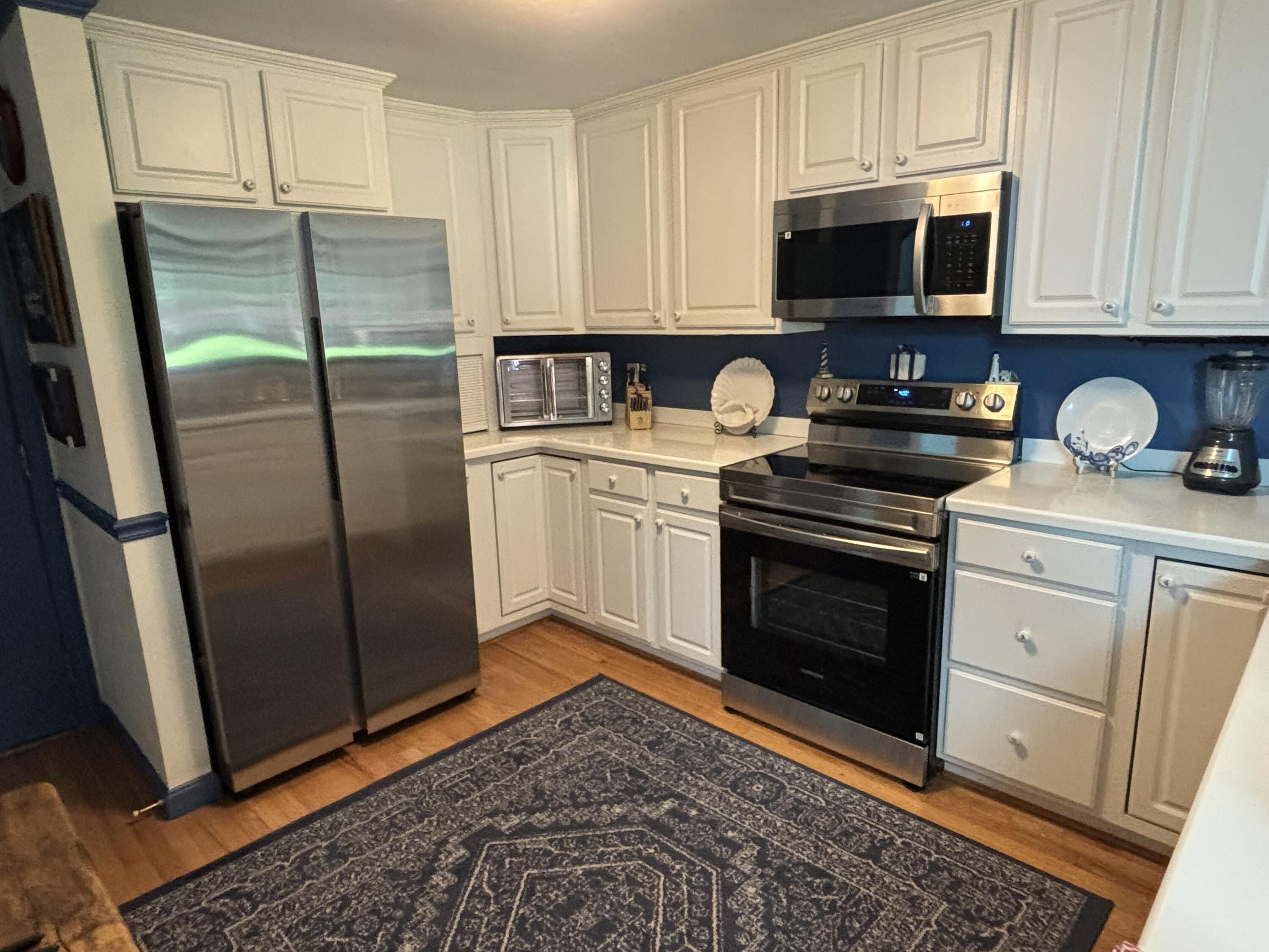 14 Pga Lane Mashpee, MA 02649 - Photo 7 of 14 a kitchen with stainless steel appliances granite countertop a stove a microwave and a refrigerator