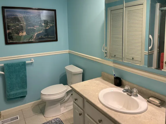a bathroom with a toilet sink and mirror