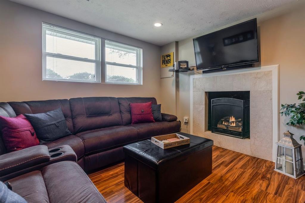 133 Glengarry Drive Coraopolis, PA 15108 - Photo 23 of 24 a living room with furniture a flat screen tv and a fireplace