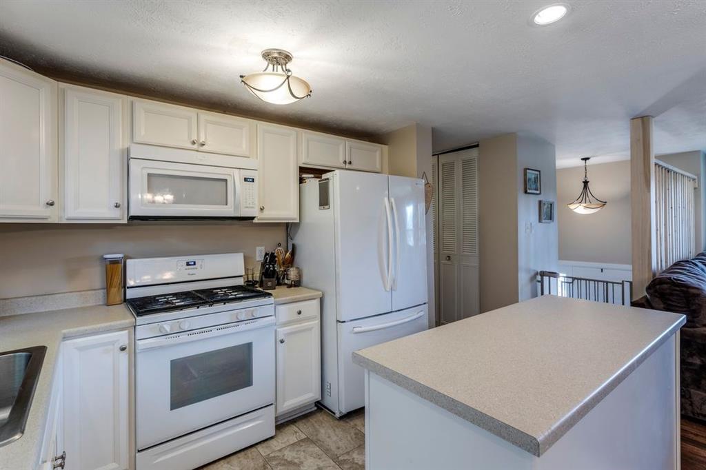 133 Glengarry Drive Coraopolis, PA 15108 - Photo 9 of 24 a kitchen with stainless steel appliances a stove a microwave a refrigerator a sink and white cabinets