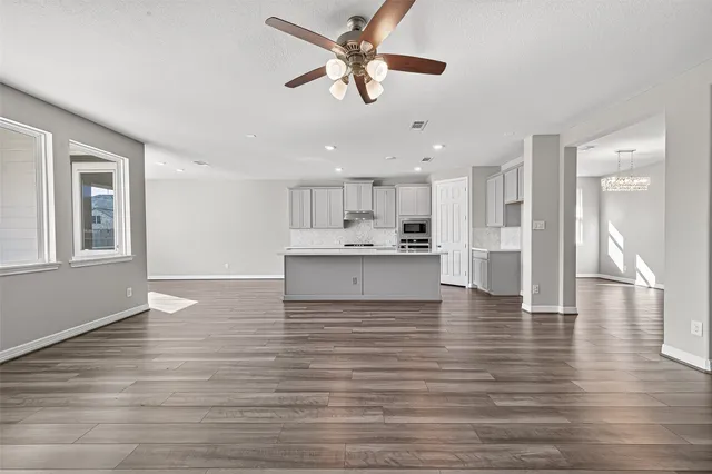 a view of kitchen with granite countertop cabinets and wooden floor