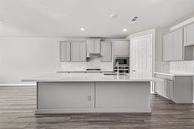 a large kitchen with cabinets