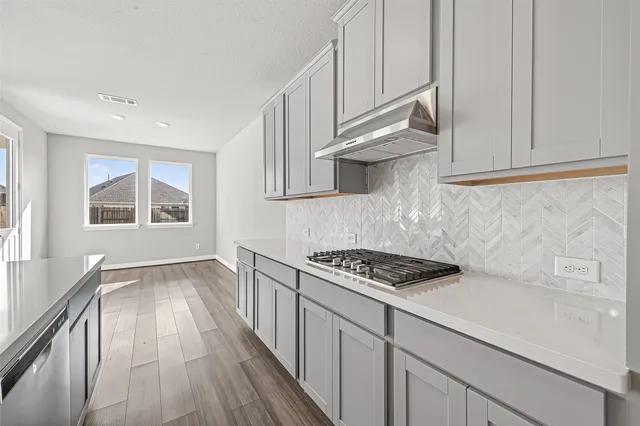 a kitchen with cabinets and window