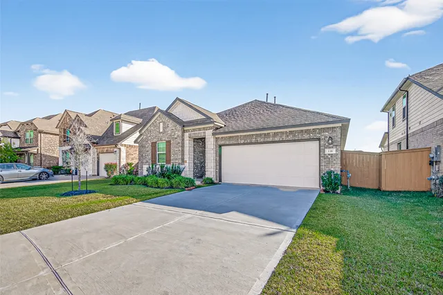 a view of a house with a yard and pathway