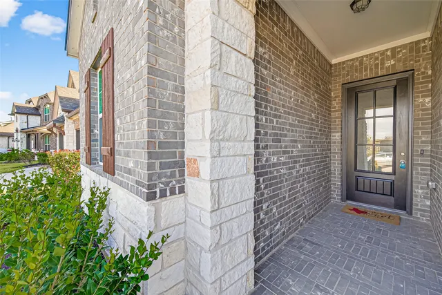 a pathway of a house with a yard