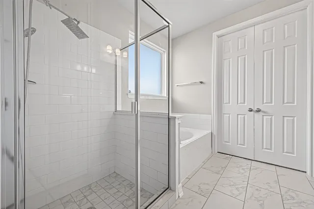 a bathroom with a shower and a glass door
