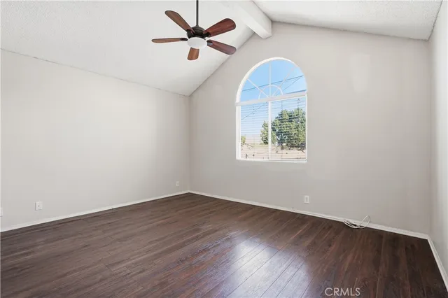 a view of a room with wooden floor and ceiling fan