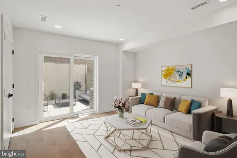 a living room with furniture and a rug