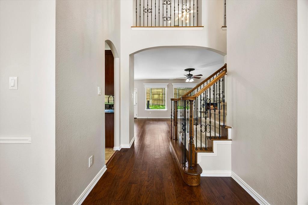 645 Channel Ridge Drive Rockwall, TX 75087 - Photo 7 of 40 Hardwood flooring flows from the foyer to the family room.