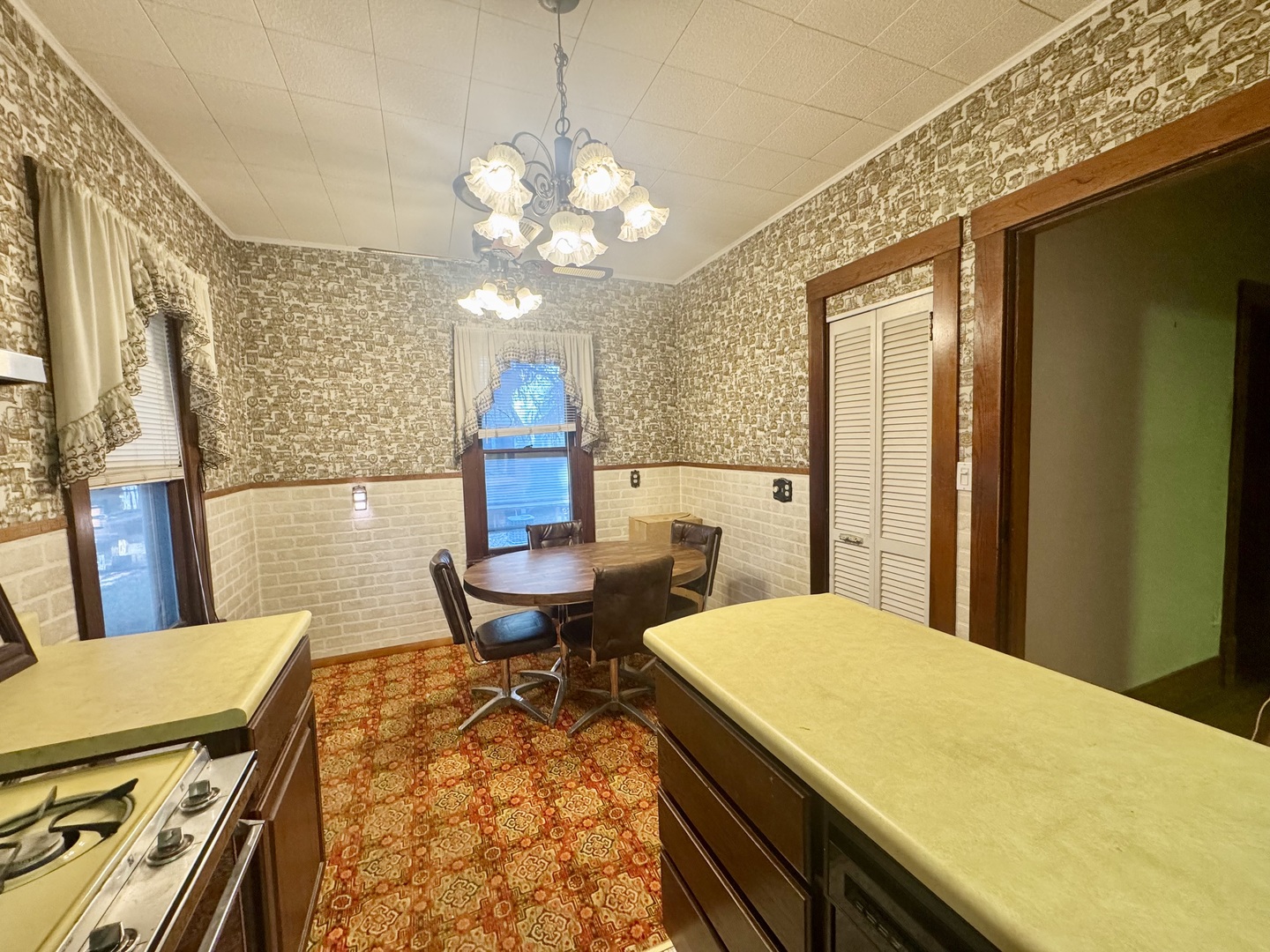 303 South Elm Street Clinton, IL 61727 - Photo 5 of 17 a view of a dining room with furniture a chandelier and wooden floor
